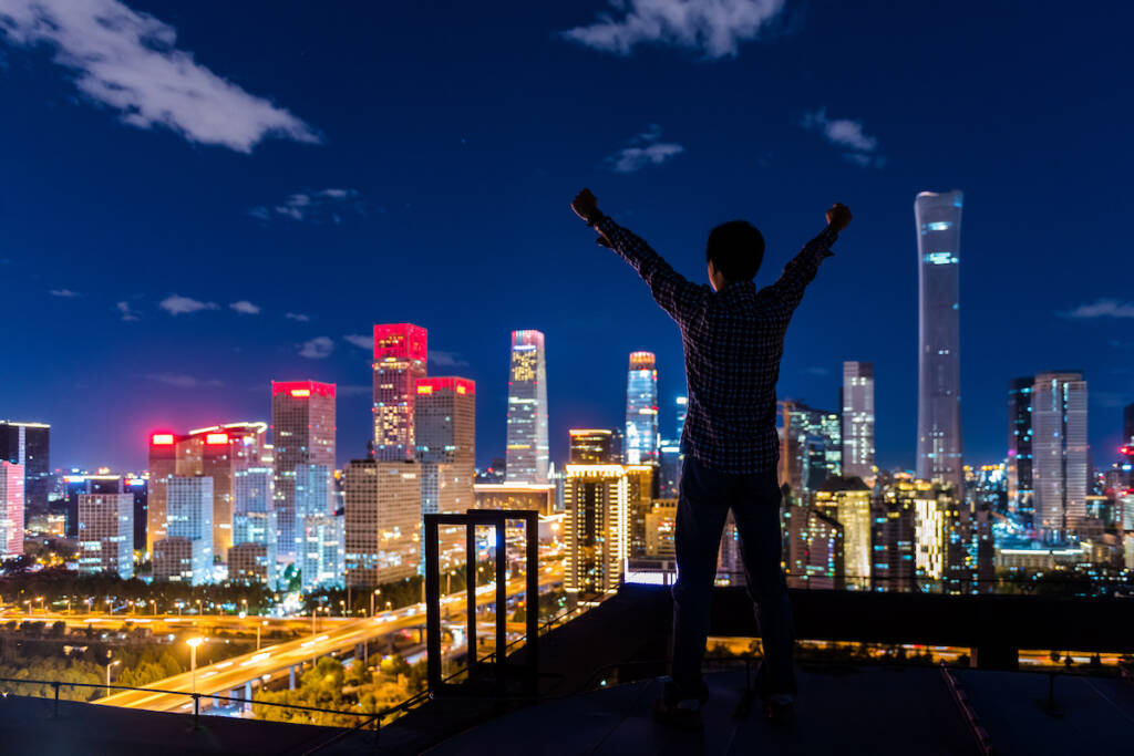 Man standing in front of a modern cityscape